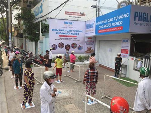 People queue for free rice at a 