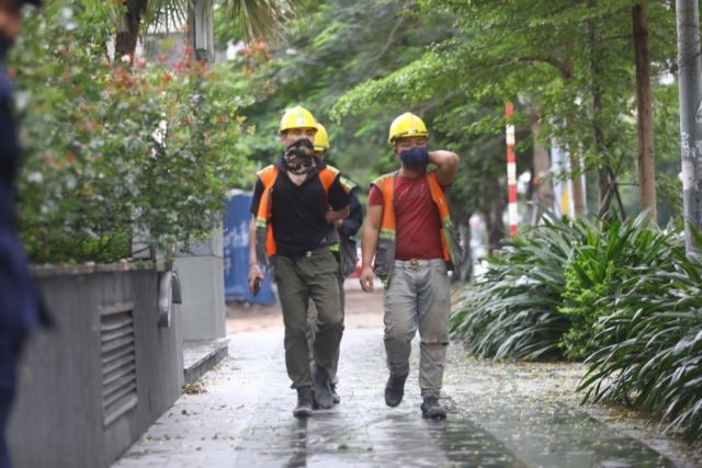 Construction workers are pictured on their way to aconstruction site onApril 23.