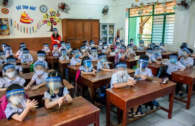 Primary students at Nui Thanh School in Danang City wear both face masks and face shields