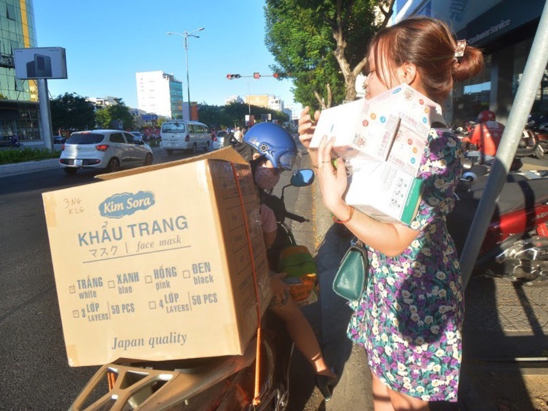 Van Thi Thao, 27, buys boxes of masks for her family, friends and colleagues.