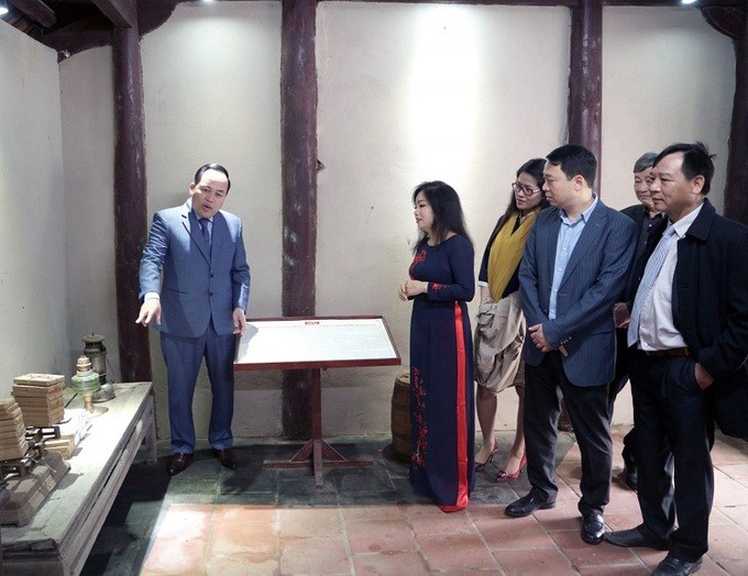 Tuan (L) shows delegates at the Institute of Psychological Studies and Support for Drug Users the displayed pieces of equipment for drug usage in Hanoi, March 2021. Photo courtesy of PSD.