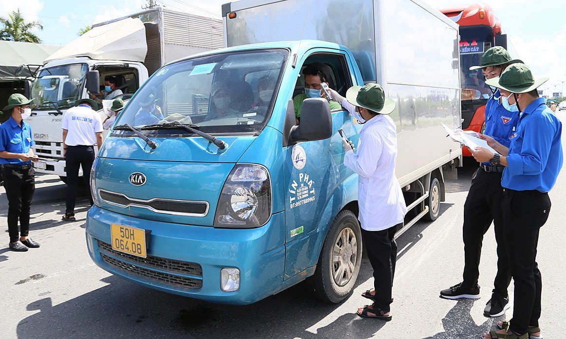 A task force checks body temperatures of truck drivers from HCMC to Can Tho City, May 30, 2021. Photo by VnExpress/Cuu Long.