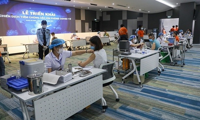 People in HCMC get Covid-19 vaccines on June 19, 2021. Photo by VnExpress/Quynh Tran.