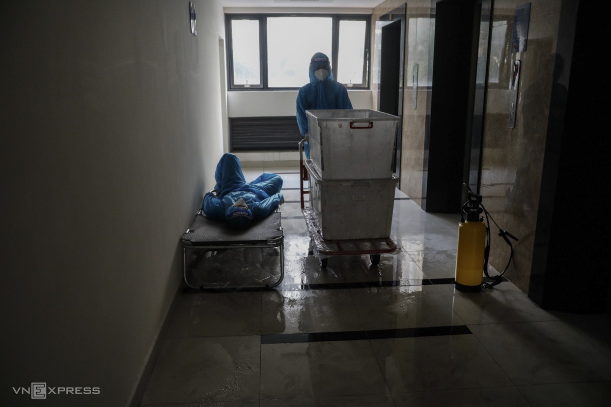 A staff takes a rest after one hour delivering food to thousands of patients. Aside from medical workers, around 100 militias have been mobilized at the hospital.