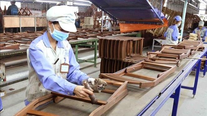 Manufacturing wooden furniture for export at Woodsland Tuyen Quang. (Photo: VNA)