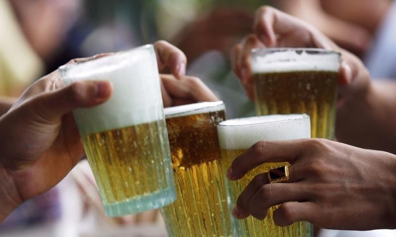 Men drink beer at a restaurant in Hanoi in a file photo by Reuters. Alcohol abuse contributes to increasing rate of liver cancer among Vietnamese male patients, doctors said.