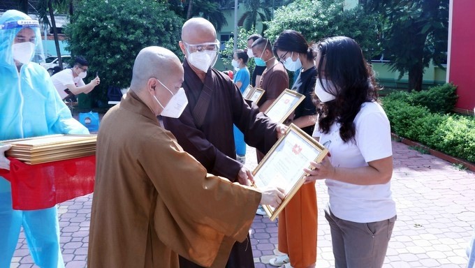 Religious volunteers receive certificates of merit. (Photo: VNA)