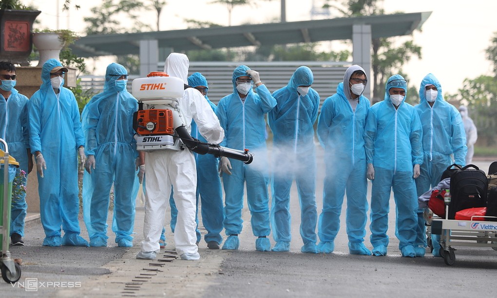 Khử trùng cho người về từ Guinea Xích đạo trước khi cách ly, chiều 29/7. Ảnh: Ngọc Thành.