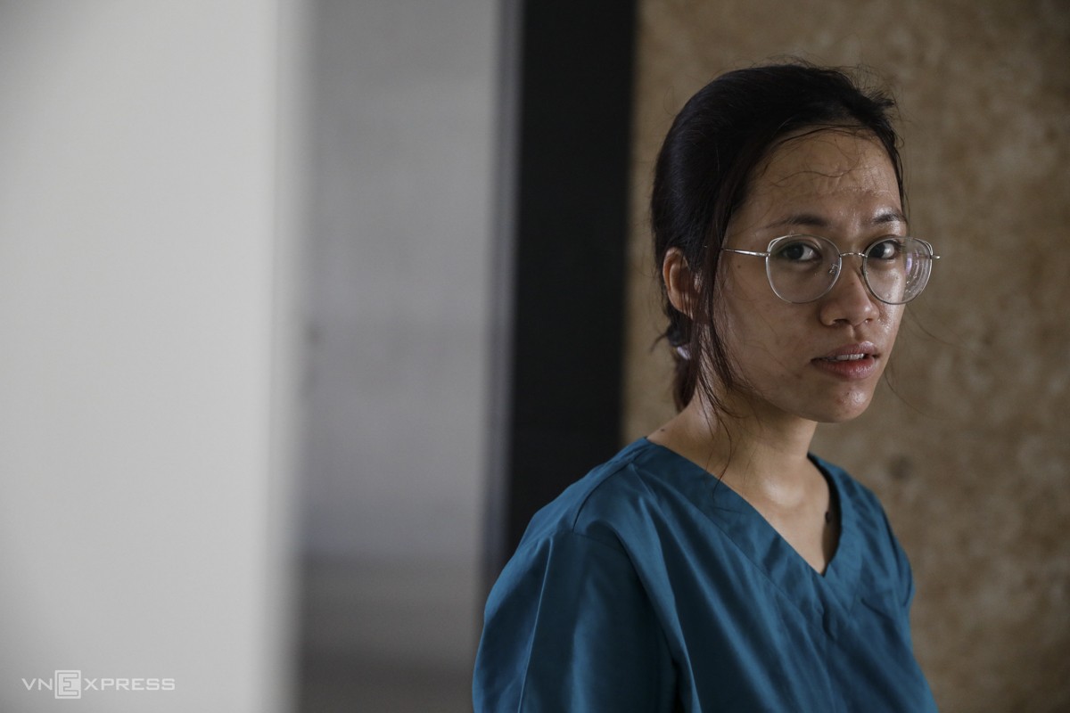 Thu is seen drenched in sweat after removing her protective gear. She said every day she has to wear the suit six to seven hours and sometimes does not dare take any food or drink while on duty, fearing it could make her infected.
