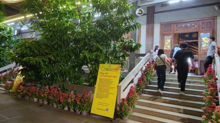 Phía ngoài nhà chùa dựng bảng thông báo các hoạt động từ 1 đến 15 âm lịch